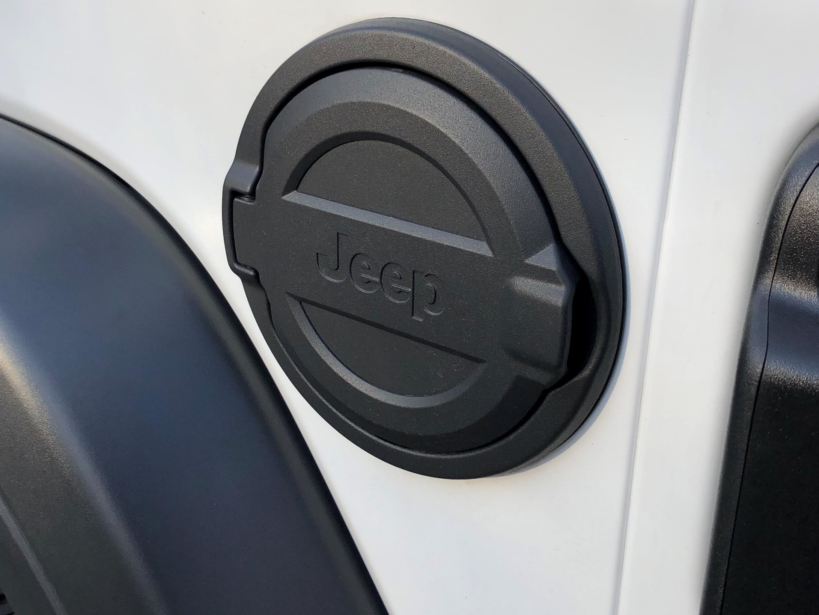 Mopar Jeep Wrangler Fuel Door with Jeep Logo; Black 82215123AB (18